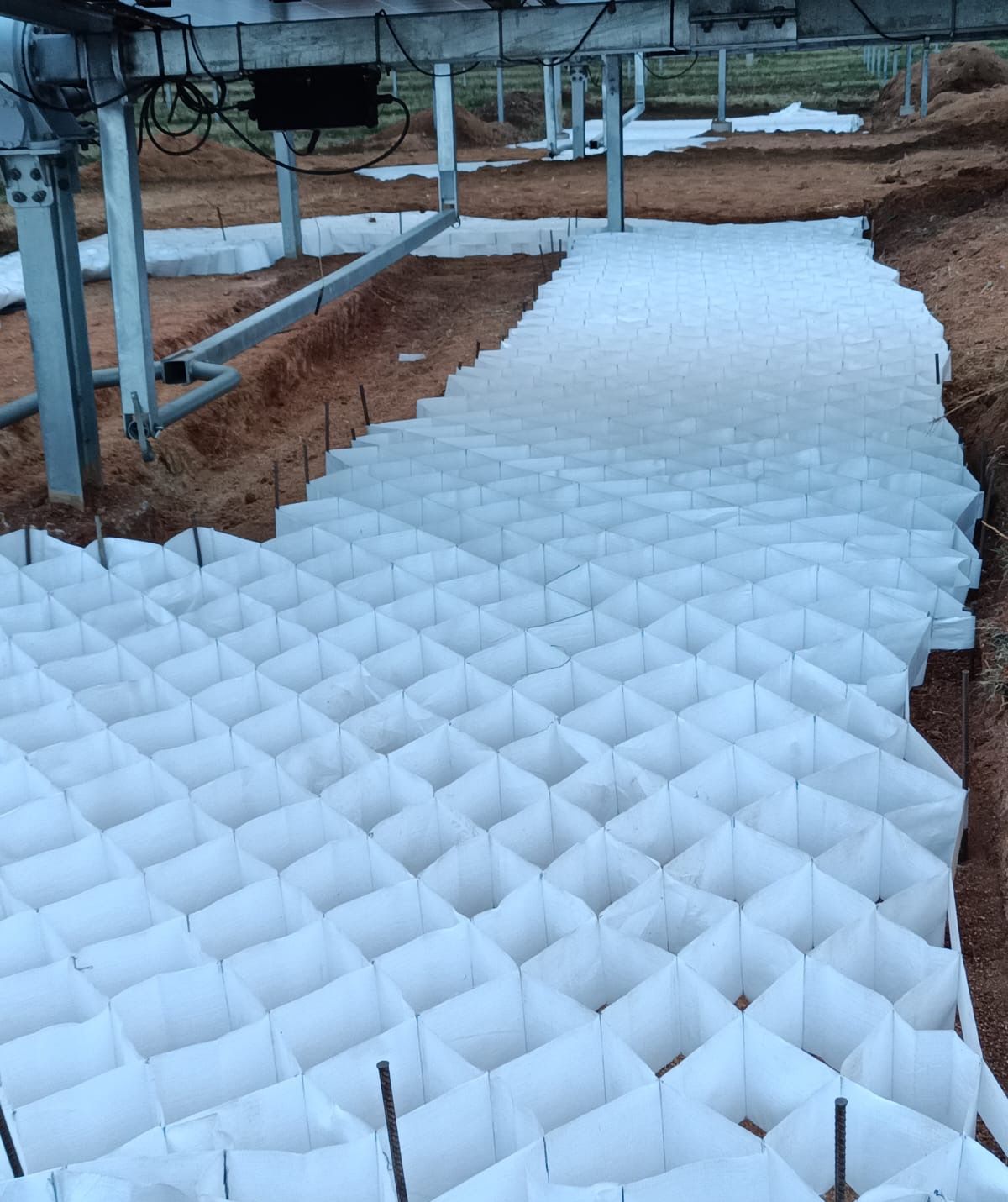 White Greencell / Multicell panels pinned in place under solar panels at Balfour