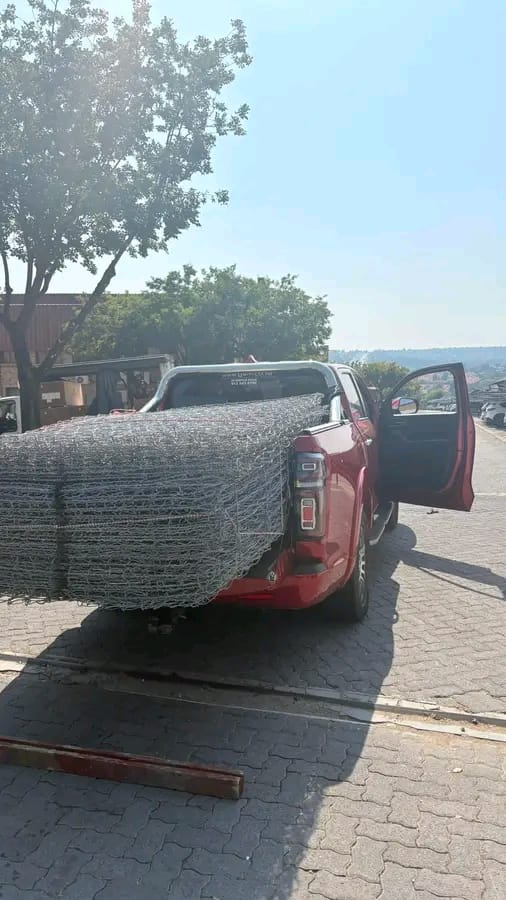 Red bakkie loaded with bundles of gabion mesh, delivered to the Fairlands project
